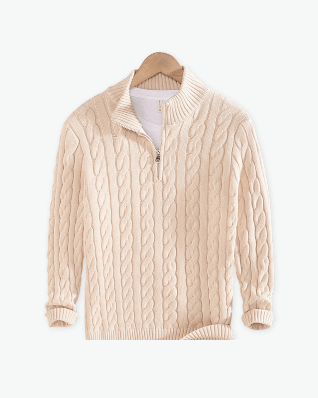 Beige cable knit sweater on a white background