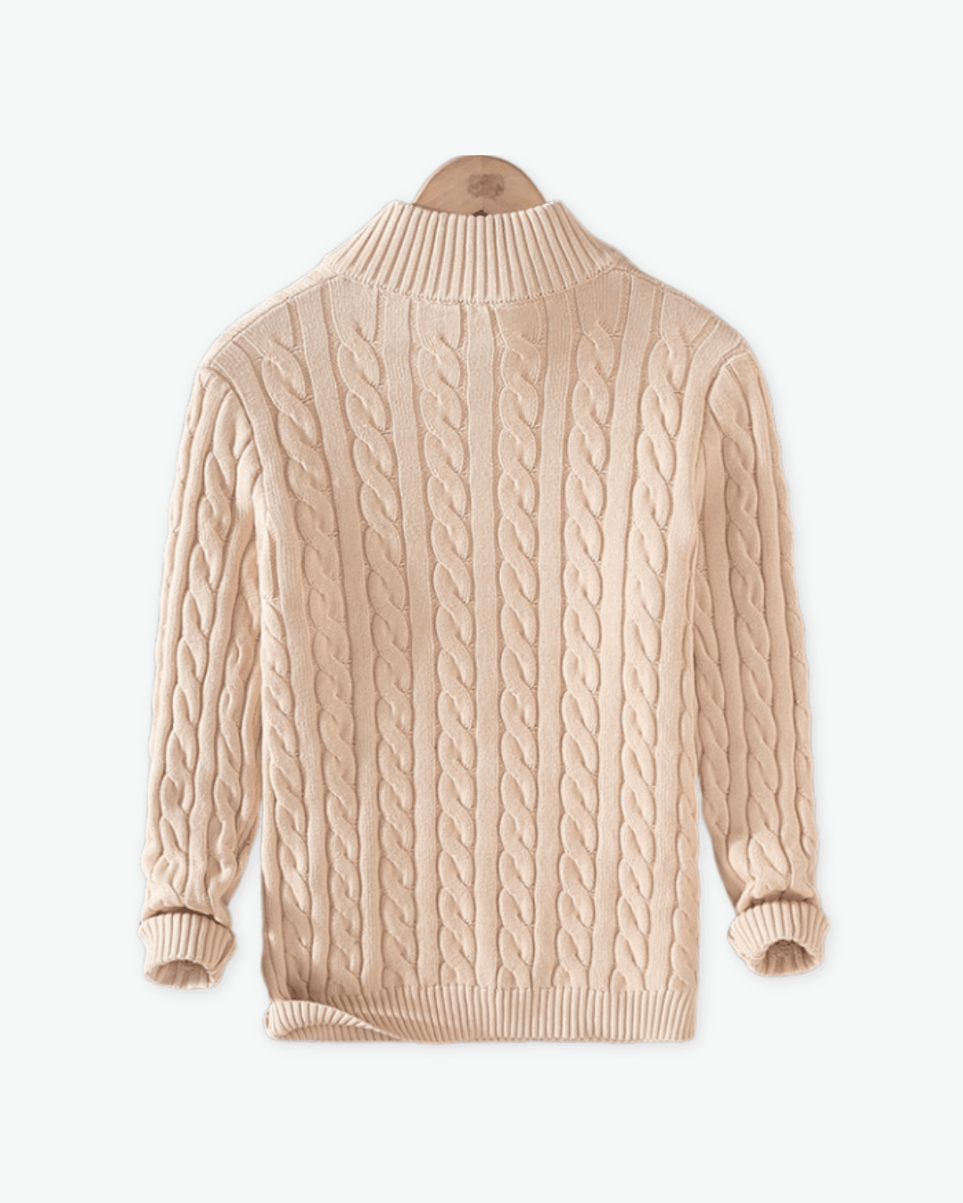 Beige cable knit sweater on a white background