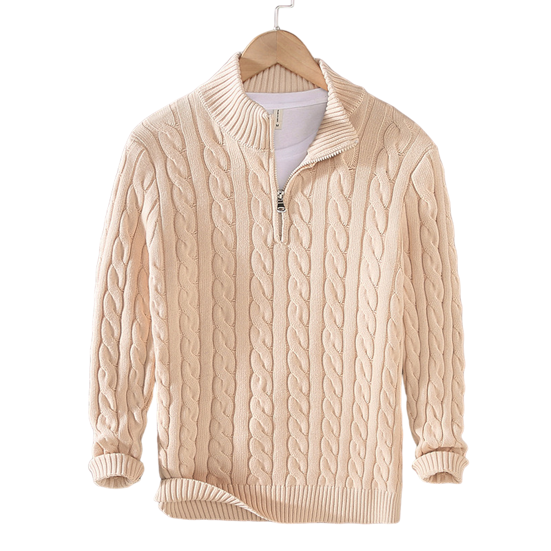 Beige cable knit sweater on a hanger against a white background